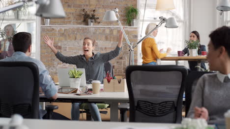 business woman with arms raised celebrating success watching sport victory on laptop diverse people group clapping expressing excitement in office