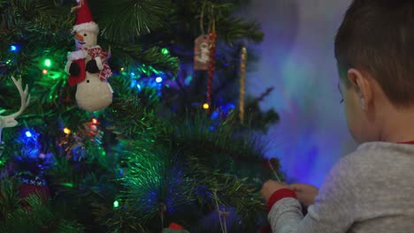 A-little-boy-decorating-his-Christmas-tree