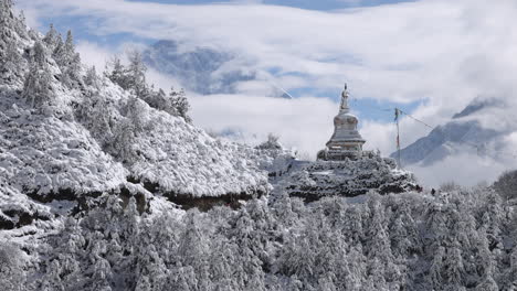 slow motion of people walking along snow covered trail near a stupa in nepal.