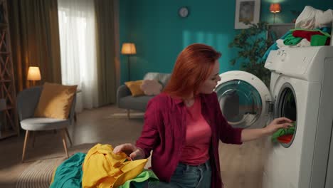 woman doing laundry and playing with a teddy bear at home