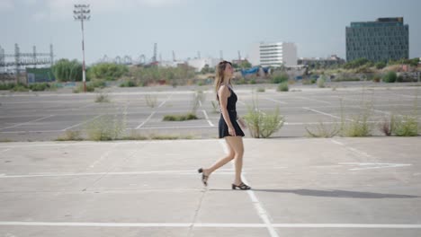 woman walking in an urban parking lot