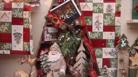 wooden christmas figures and gifts on a store display in germany at a festive christmas market in europe