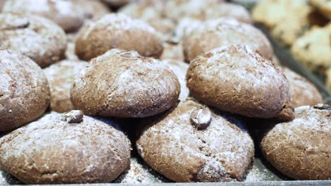tray of brown cookies with powdered sugar and coffee beans