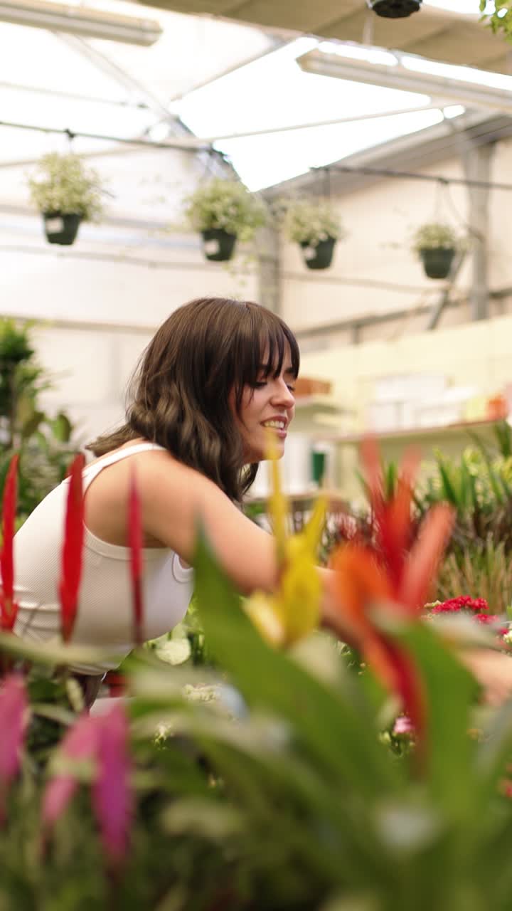Customers choosing plants in garden center. Vertical