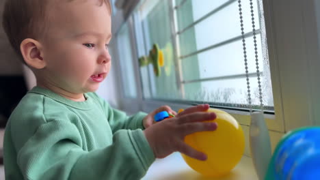 baby boy playing at the window