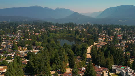 scenic aerial view flying toward como lake park in picturesque coquitlam, greater vancouver