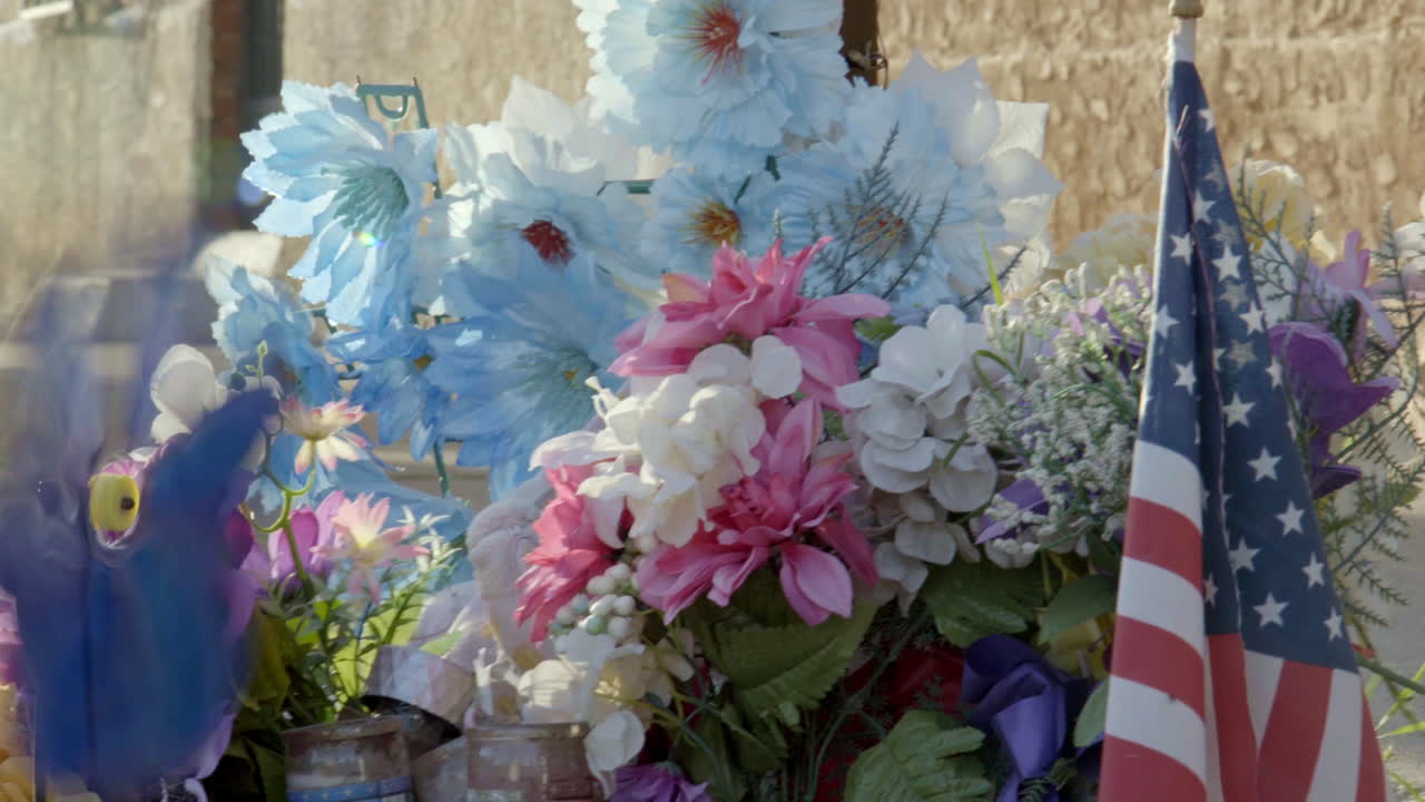 Close-up View of Flowers and Candles at a Murder Victims' Location