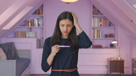 sad indian girl checking pregnancy test