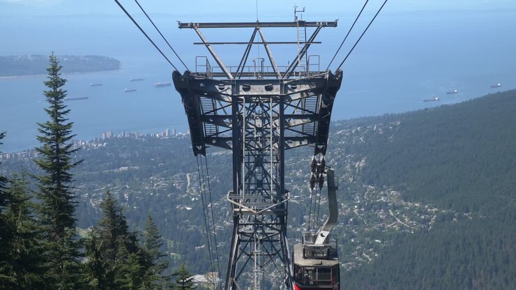 Cable Car With Tourists Going Down The Mountain In Daytime