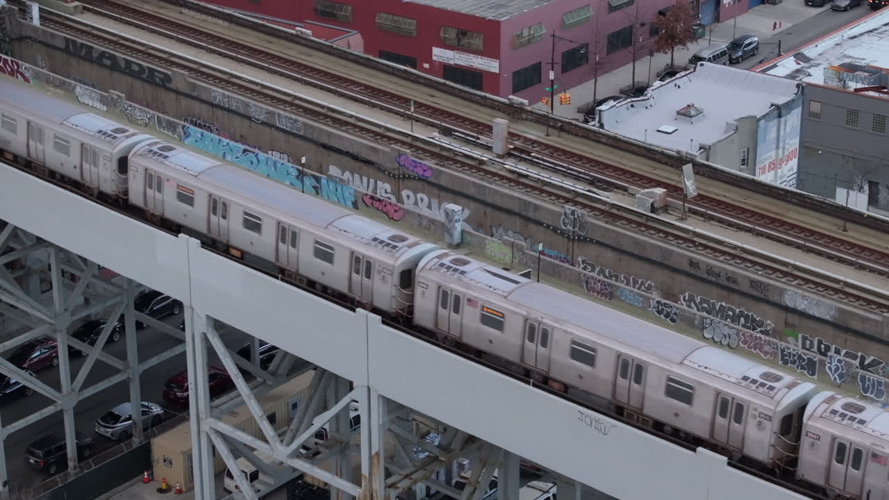 Aerial view of the subway on an elevated railway track in Brooklyn. Shot on an overcast day in Gowanus.