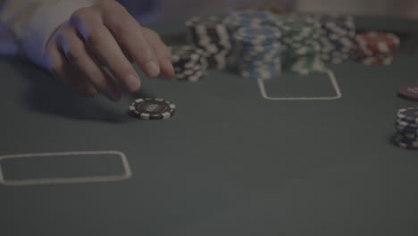 close up shot of a person flipping a poker chip in slowmotion on a poker table log