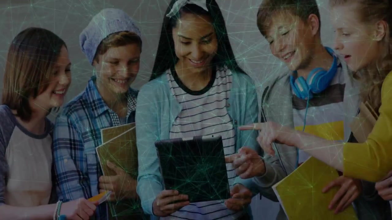 Teen holding tablet and tapping, peers leaning in and pointing, sharing school content
