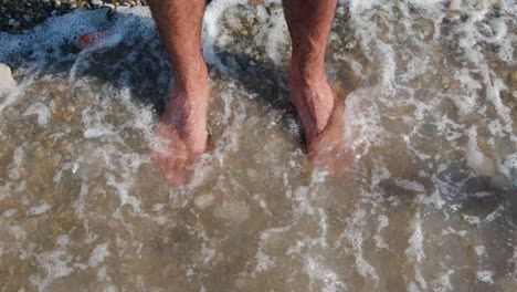 barefoot on a pebble beach