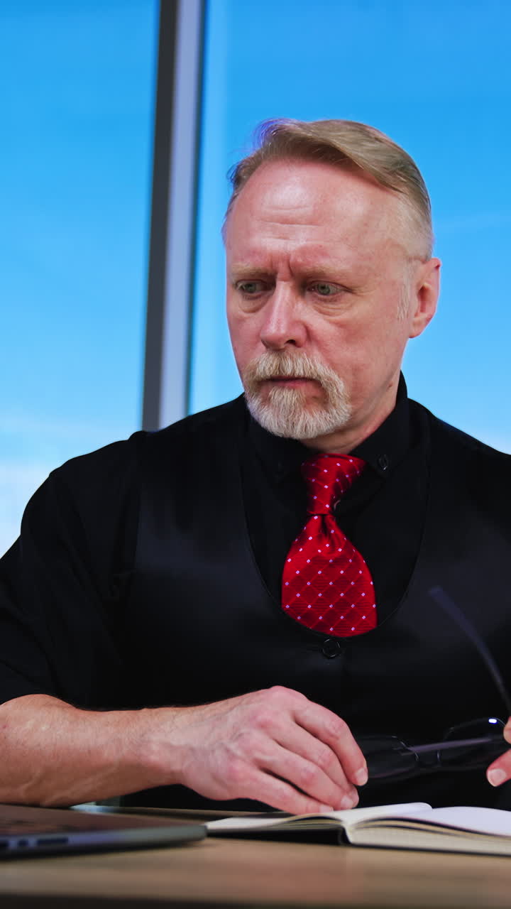 Mature middle age in casual cloth. Stylish handsome businessman working in the office. Vertical video