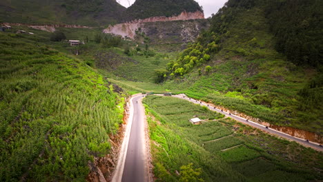 group of motorcyclists on adventure trip riding along ha giang loop