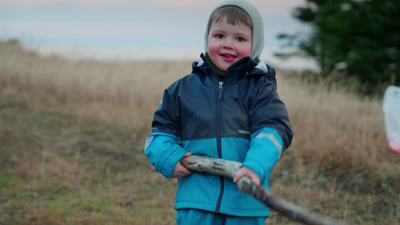 niño jugando con un palo en un pequeño arroyo en el país