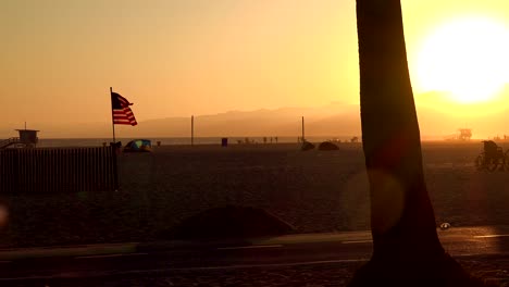 american flag on the beach at sunset