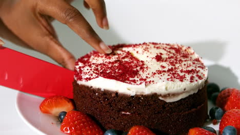 Chocolate-cake-about-to-be-cut-by-a-woman