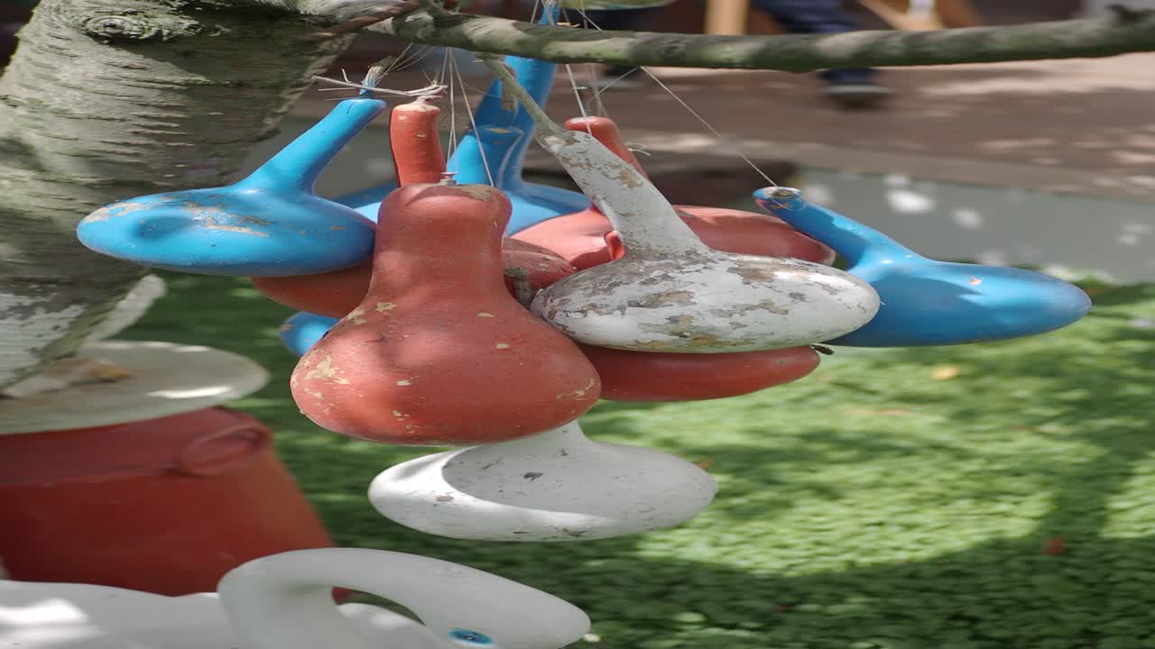 Colorful Painted Gourds Hanging from a Tree Branch