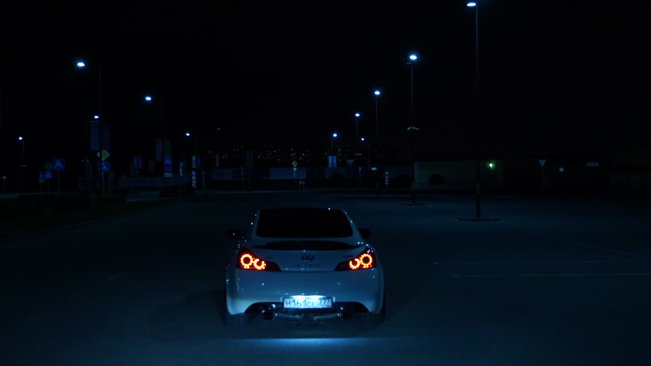 Infiniti G37 in a parking lot at night