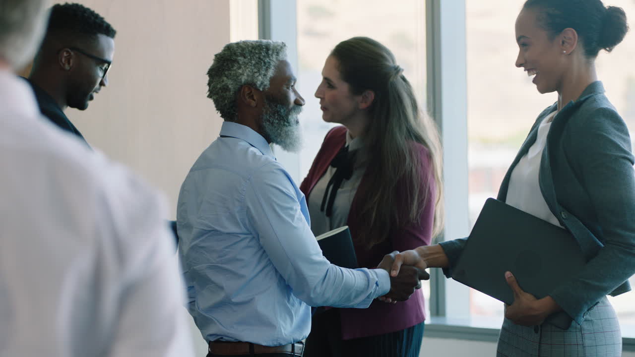 diverse business people meeting shaking hands in boardroom preparing for conference collaborating with clients shareholders planning partnership deal in corporate office