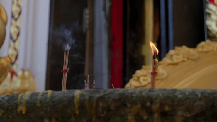 candle and sunshine inside a temple in Thailand