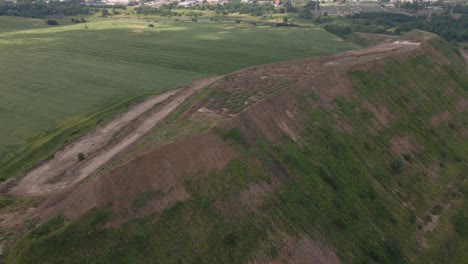household waste landfill. closed for processing. environment protection. close-up shot. the city is visible on the horizon. close-up shot. aerial photography