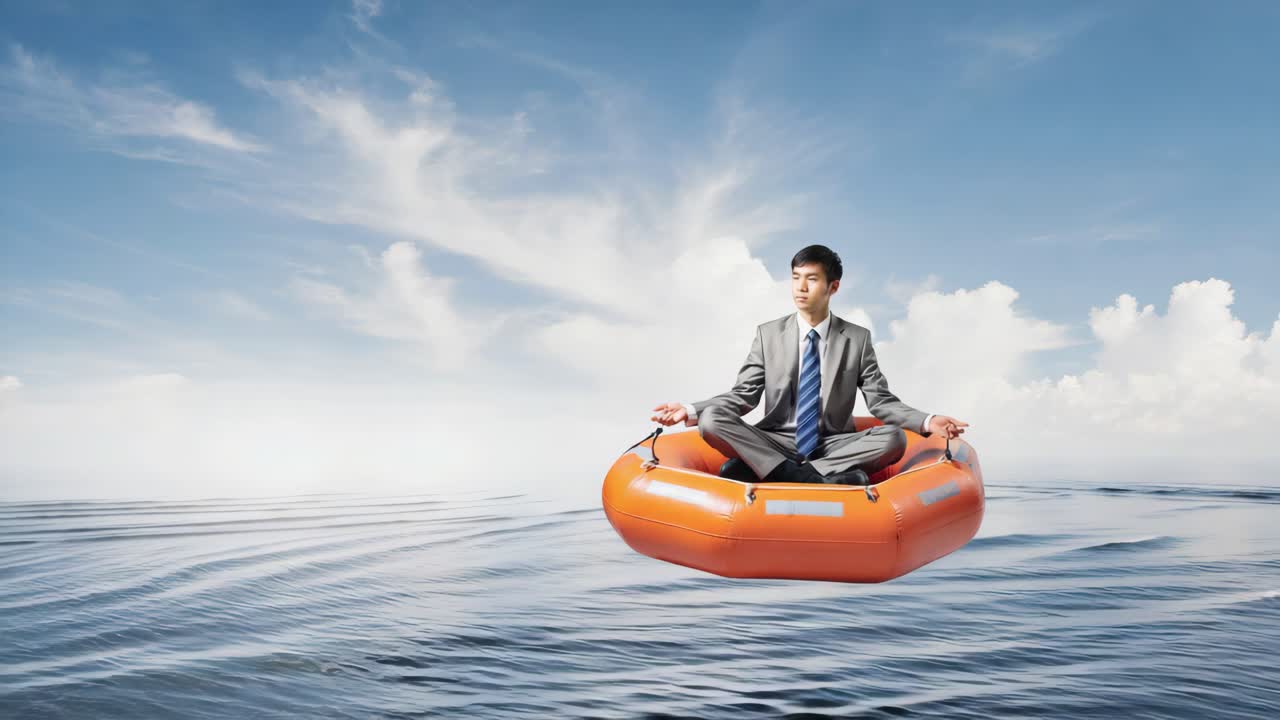 Businessman Meditating in a Lifeboat on the Ocean