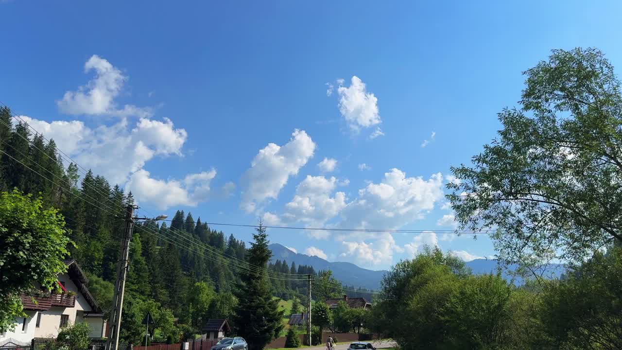 Sunny Rural Mountain Landscape with Blue Sky and White Clouds