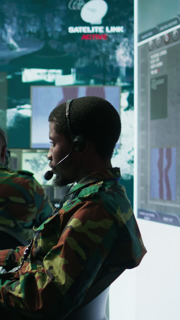 Vertical Video Team of military specialists in command post monitoring satellite data