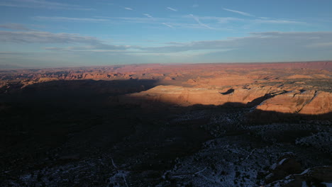 Drone-shot-flying-over-southwestern-mountains-in-dramatic-lighting