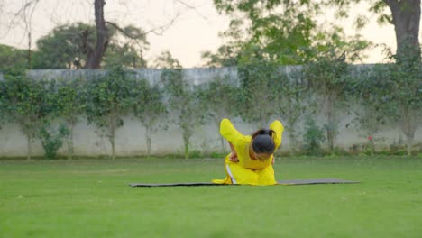 Niña-India-Haciendo-Yoga-Avanzado-En-Un-Parque