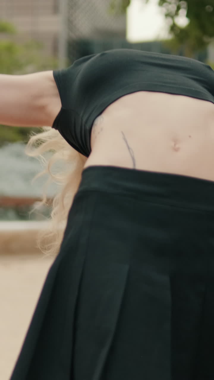 Young Woman in Black Skirt Stretching Her Body Outdoors