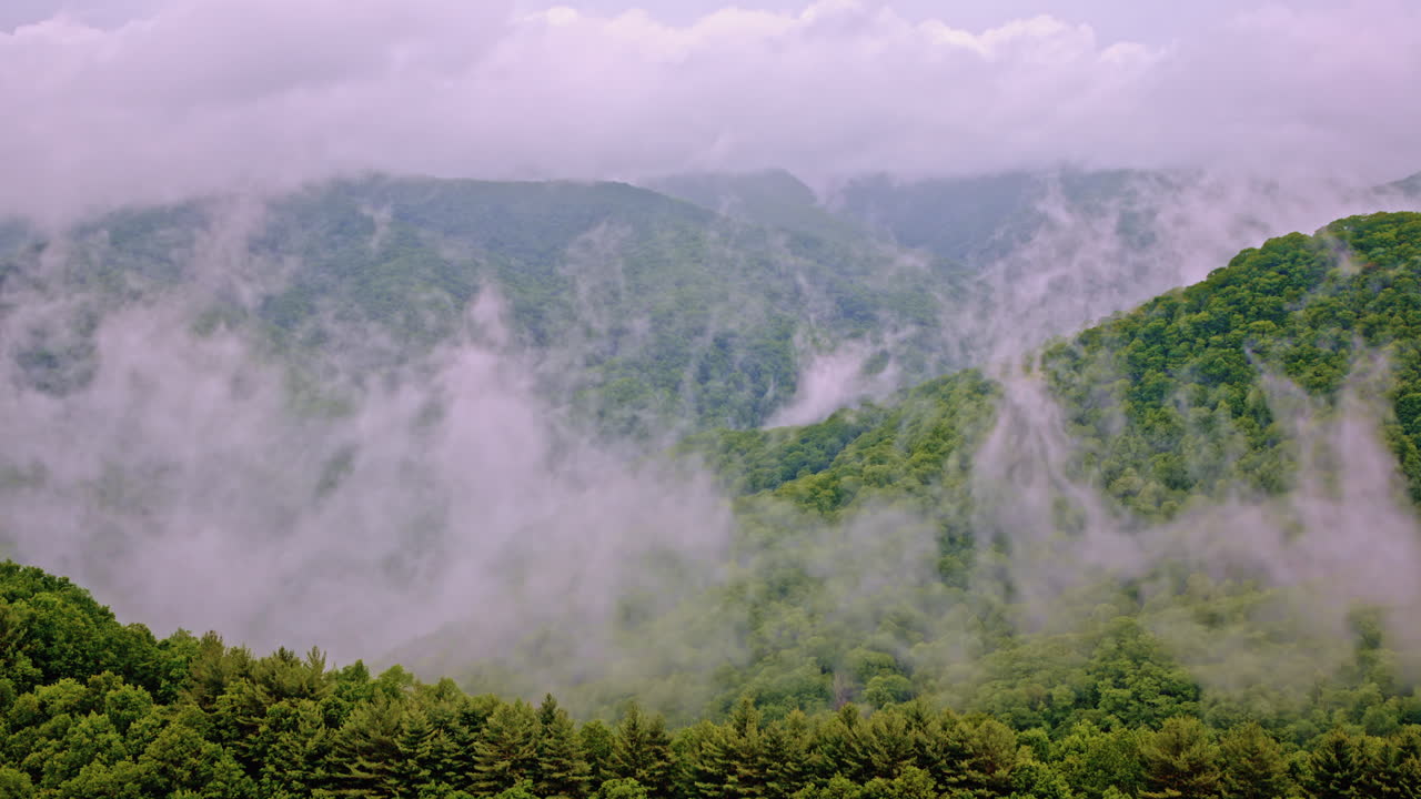 Cinematic aerial shot of the fog-draped Smoky Mountains