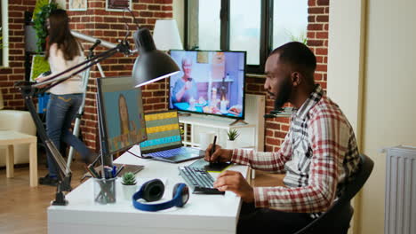 African-american-male-designer-edits-images-on-dual-monitors