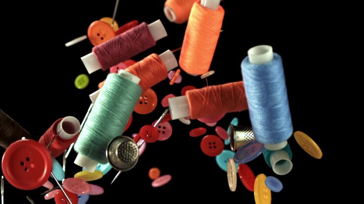 Colorful Sewing Thread Spools and Buttons Falling in Slow Motion