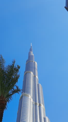 burj khalifa with palm trees and blue sky