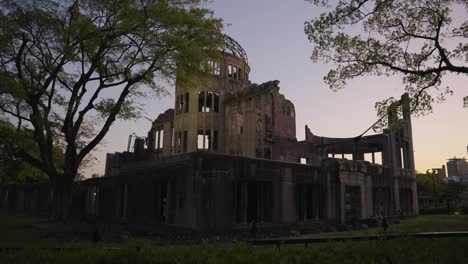 hiroshima peace park, ruins of preserved atomic dome in background in evening