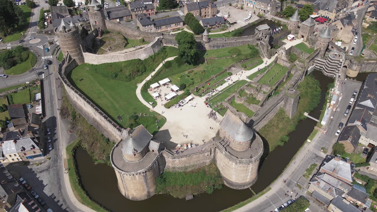 Aerial top-down rising over ramparts and moat of Fougères castle, Ille-et-Vilaine in France