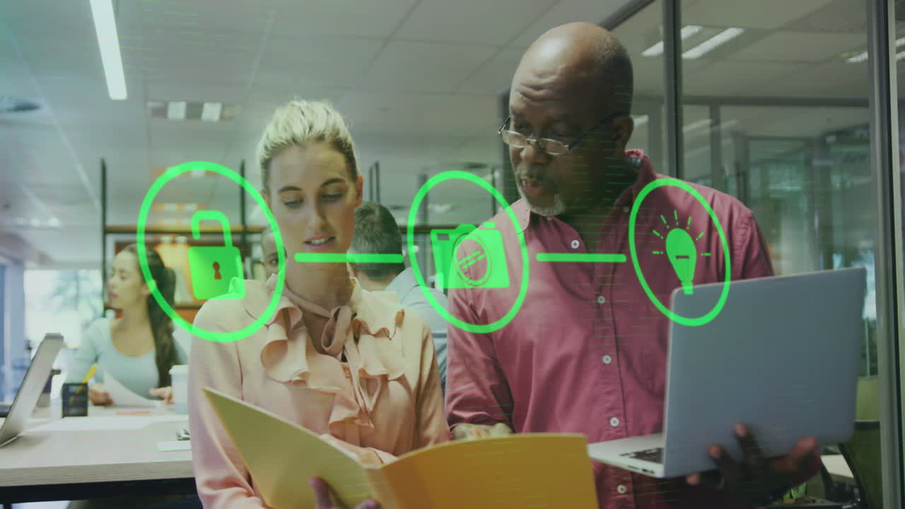 Animation of flowchart of icons over diverse coworkers discussing reports on laptop in office