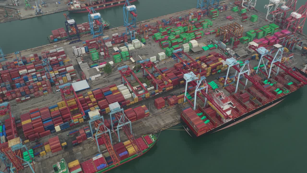 Busy Tanjung Priok seaport showing cargo ships and stacked containers