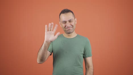 Businessman-waving-at-camera.