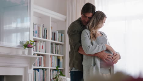 feliz pareja embarazada bailando juntos en casa marido abrazando a su esposa suavemente sosteniendo su vientre disfrutando de la danza íntima