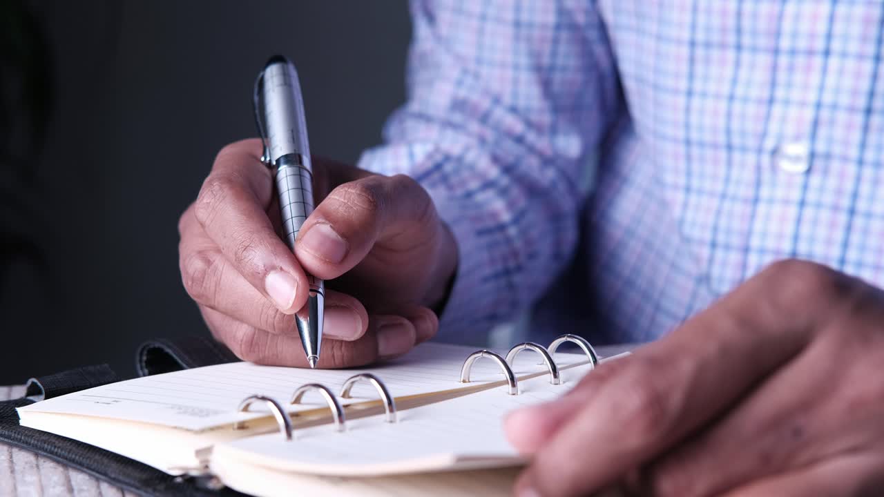 Person writing in a notebook