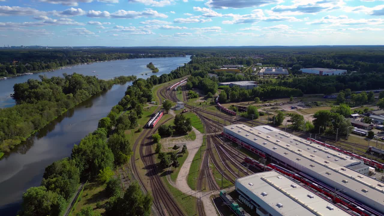 Hennigsdorf railway factory train depot overlooking the river in Brandenburg, Germany. Spectacular aerial view flight wide orbit overview drone