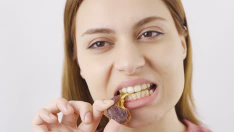 woman eating fresh dates in close-up. dry fruits.