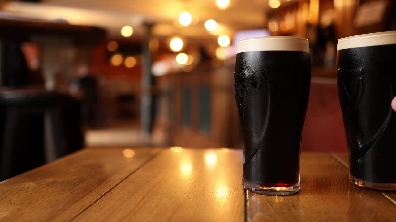 Two pints of stout on a table