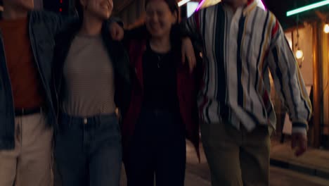 friends walking at night in a city