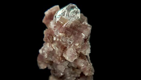 seamlessly rotating a mineral (topaz on lepidolite) in front of black background