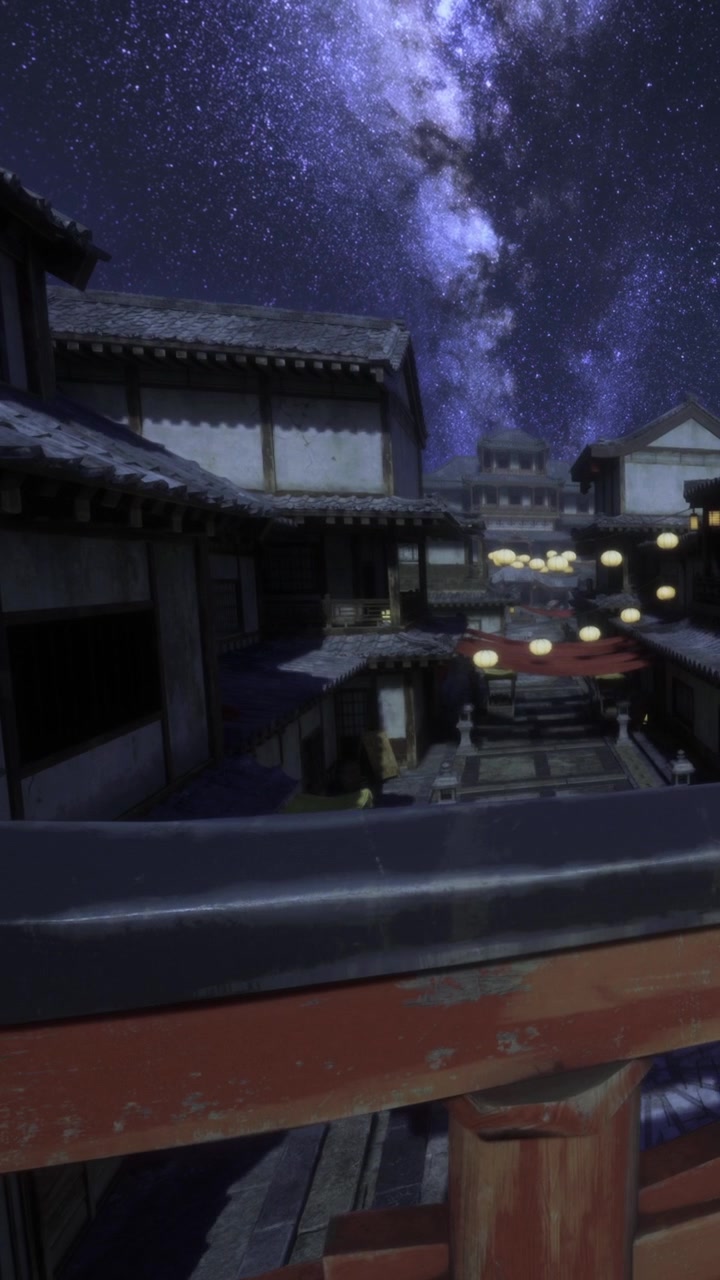 星空の下、建物とランタンが輝く夜の街の風景。